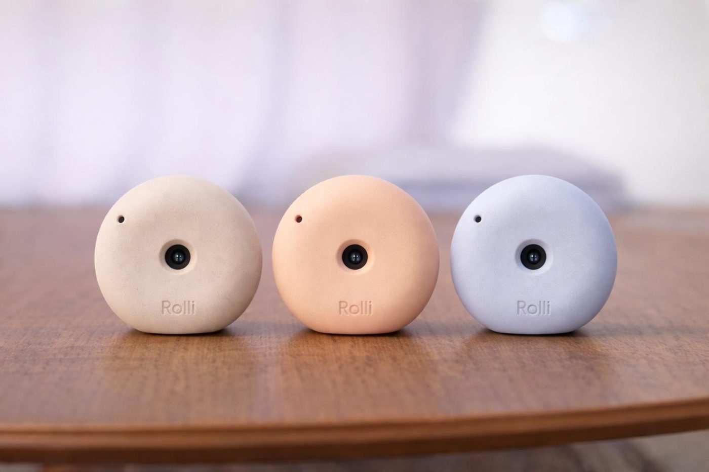 The three color versions of the monitor camera on a wooden table