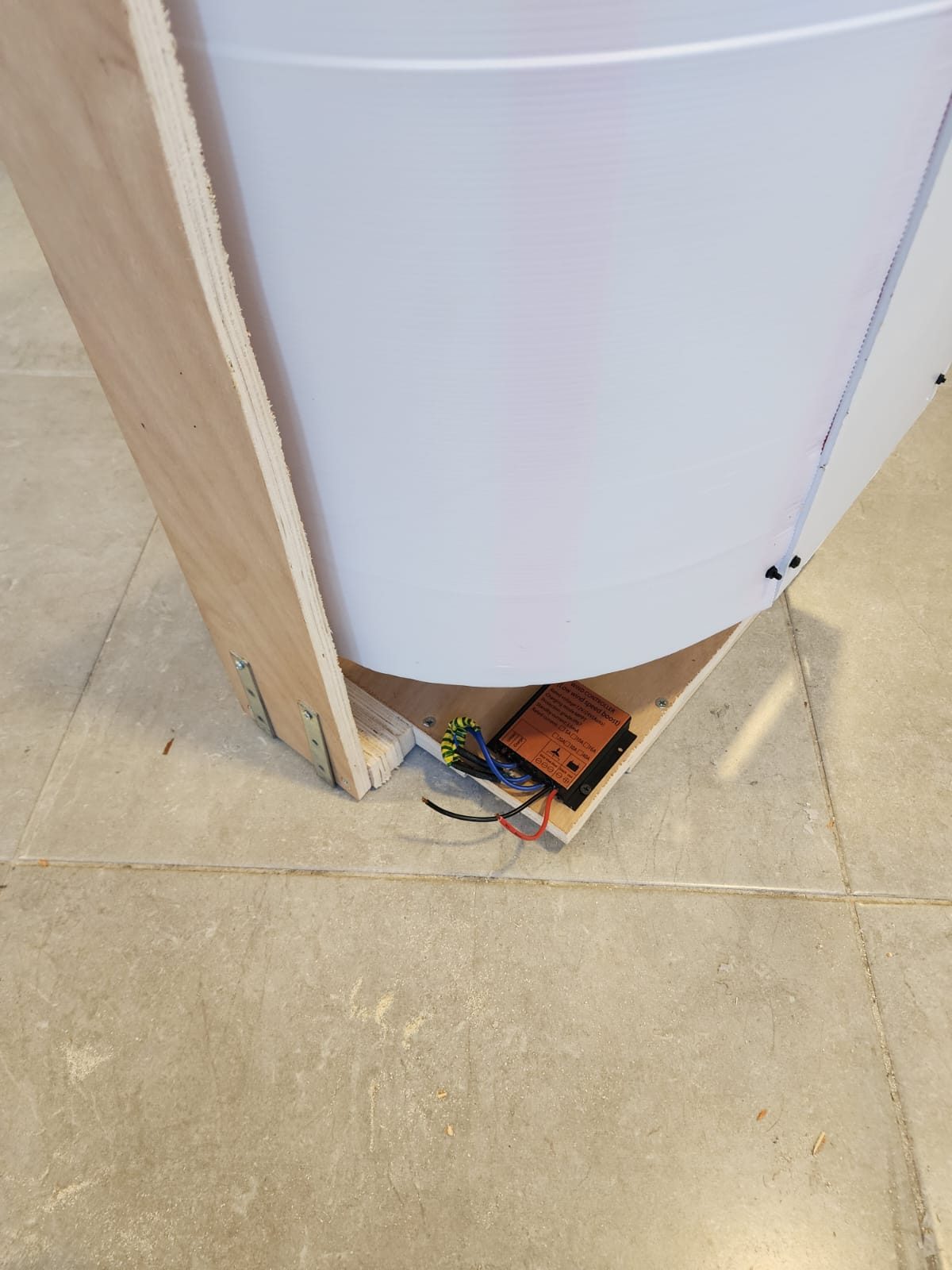 The wind charge controller wired at the base of the prototype